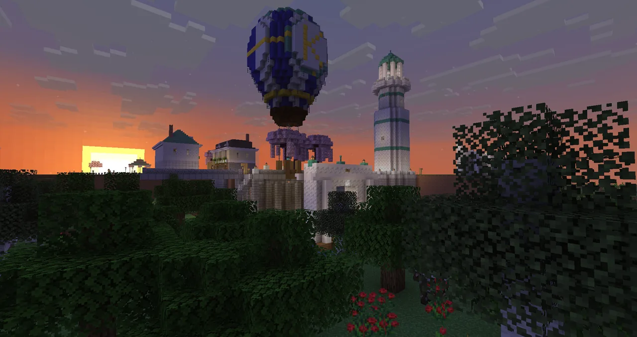 Sunset over Kettlewood: the hot-air balloon above the harbour, the lighthouse and the white houses of the town.